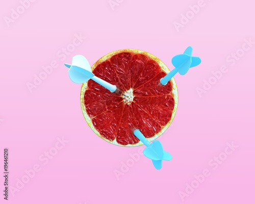 Orange fruit with circular target marked and three blue dart on pastel pink background. minimal idea food and fruit concept. Idea creative to produce work and advertising marketing. Business concepts