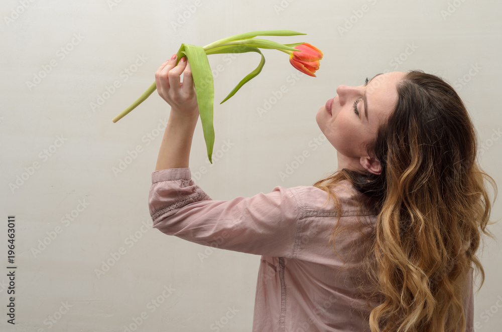 Young charming girl with a bouquet of flowers - multi-colored tulips Young charming girl with a bouquet of flowers - multi-colored tulips