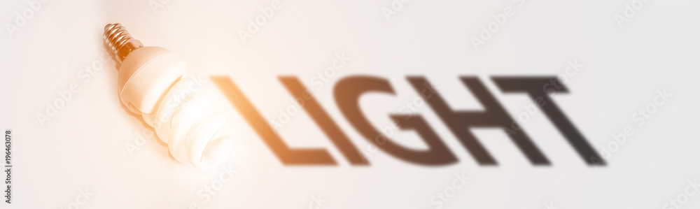 economical fluorescent lamp. the shadow of the word 'light'. economical fluorescent lamp. the shadow of the word 'light'.