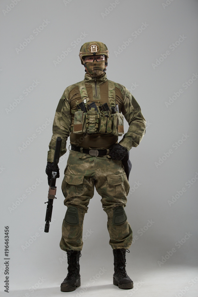 Full-length photo of military man with gun Full-length photo of military man with gun