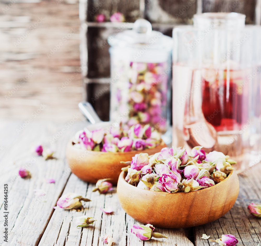 small dry buds of roses, tea, karkade, in wooden bowls, selective focus small dry buds of roses, tea, karkade, in wooden bowls, selective focus