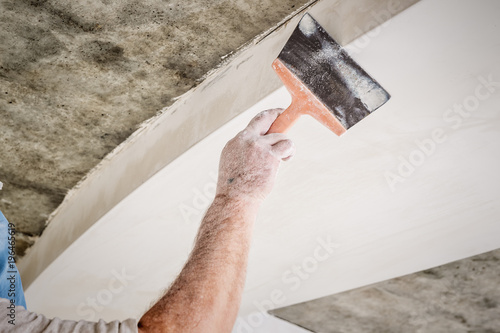 manual worker with wall plastering tools