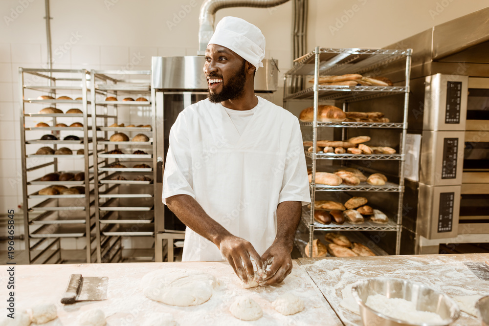 Fotografie, Obraz african american baker preparing raw dough for pastry on baking manufacture