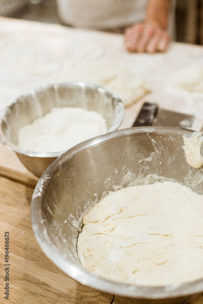 close-up shot of bowls with flour at bakers workplace