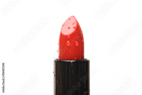 Close up of red lipstick with water droplets, isolated