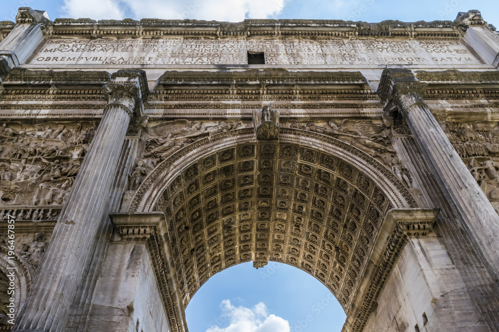 Obraz premium Roman Forum, The Arch of Septimius Severus in Rome. The Triumphal Arch of Emperor Septimius Severus, Roman forum, Rome, Italy. 