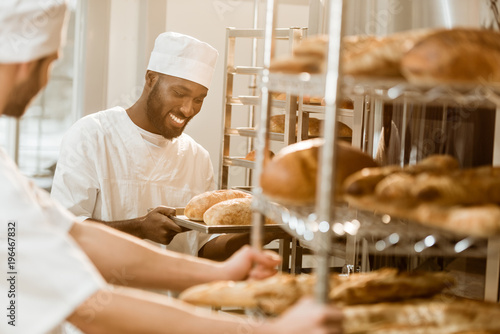 handsome bakers working together at baking manufacture photo