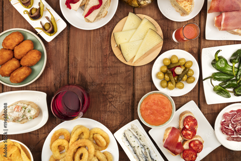 The food of Spain. Overhead photo of many different Spanish tapas with wine and copy space The food of Spain. Overhead photo of many different Spanish tapas with wine and copy space