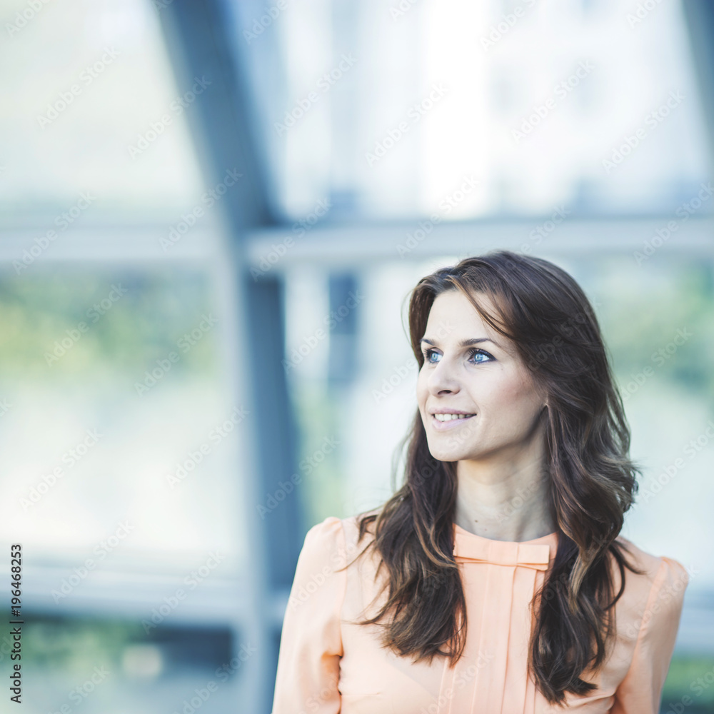 portrait of successful business woman on the background of the spacious office portrait of successful business woman on the background of the spacious office