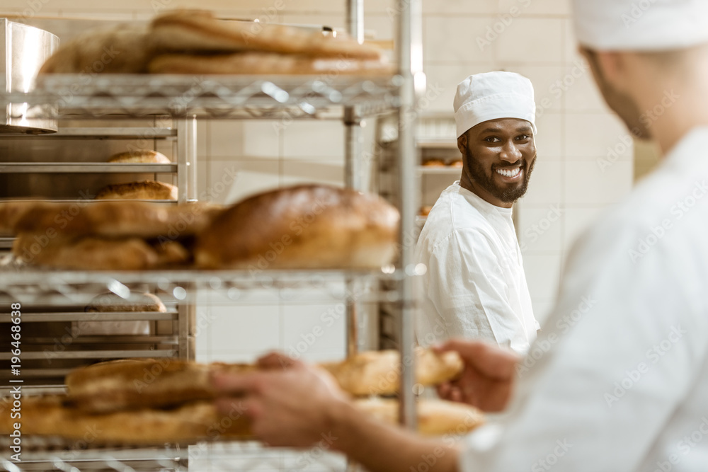 young bakers working together at baking manufacture young bakers working together at baking manufacture