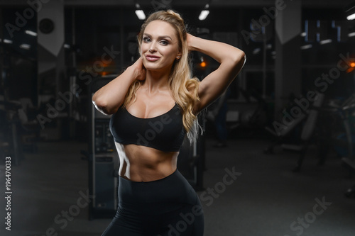 strong sexy athletic young woman working out in gym