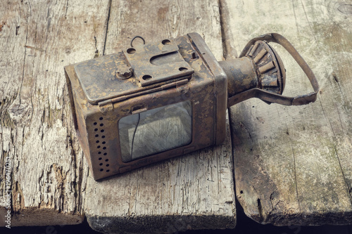 Old vintage lamp on grunge wooden table