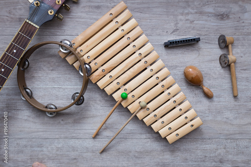 Tablou pe pânză Pack of percussion instruments on a grey wooden table