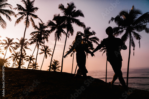Silhouettes of beautiful couple on sunset. Sri Lanka