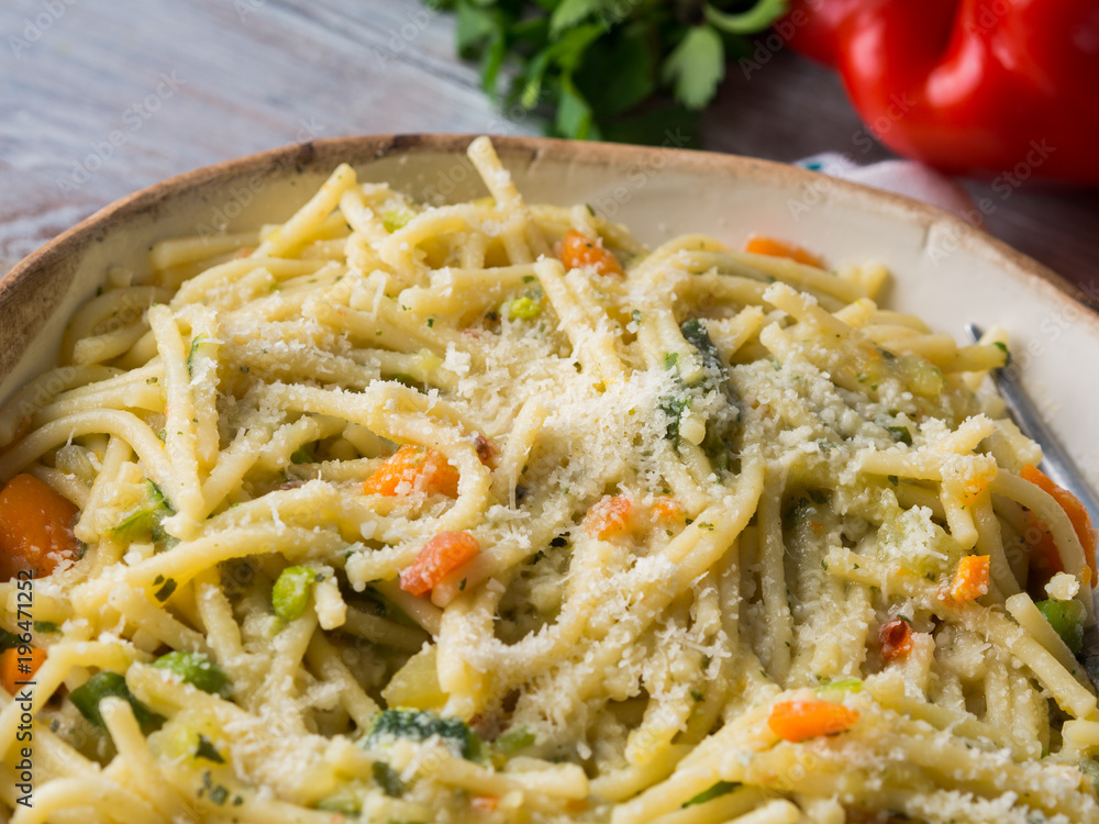 Spaghetti cooked in vegetable broth sauce on rustic wooden background. Healthy lunch Spaghetti cooked in vegetable broth sauce on rustic wooden background. Healthy lunch
