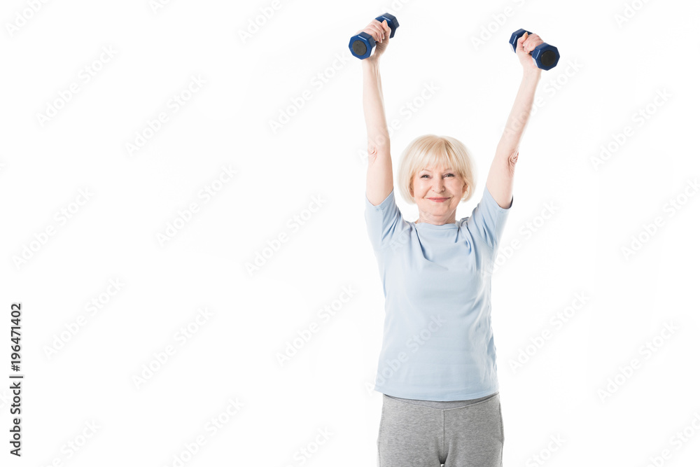 Senior sportswoman training with dumbbells isolated on white Senior sportswoman training with dumbbells isolated on white