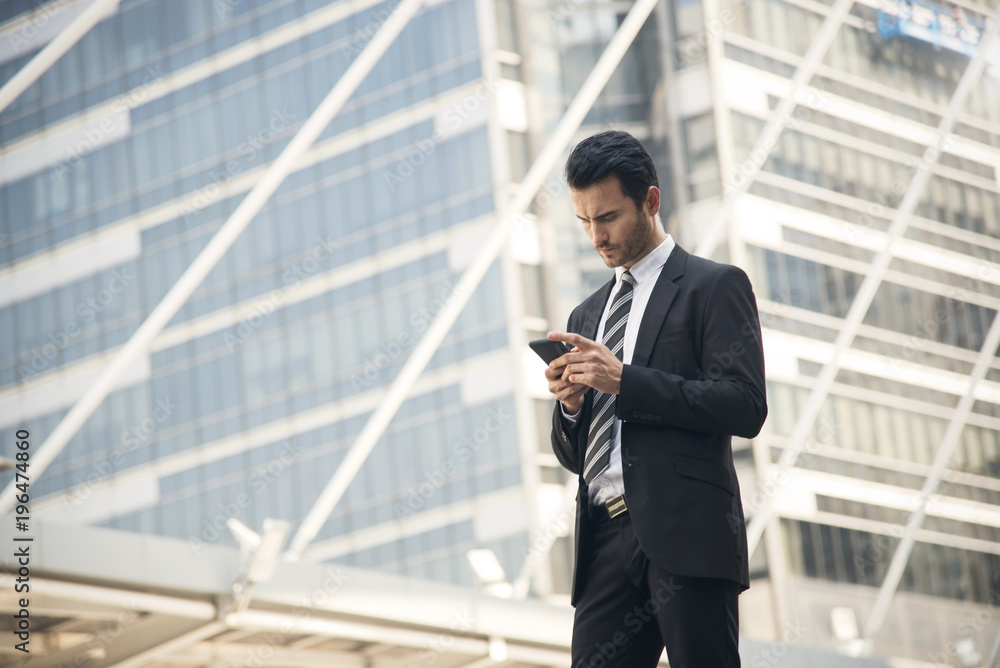 Handsome businessman using mobile phone. concept communication. Handsome businessman using mobile phone. concept communication.