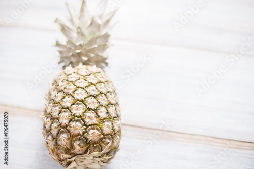 A whole ripe pineapple on an old wooden background. photo