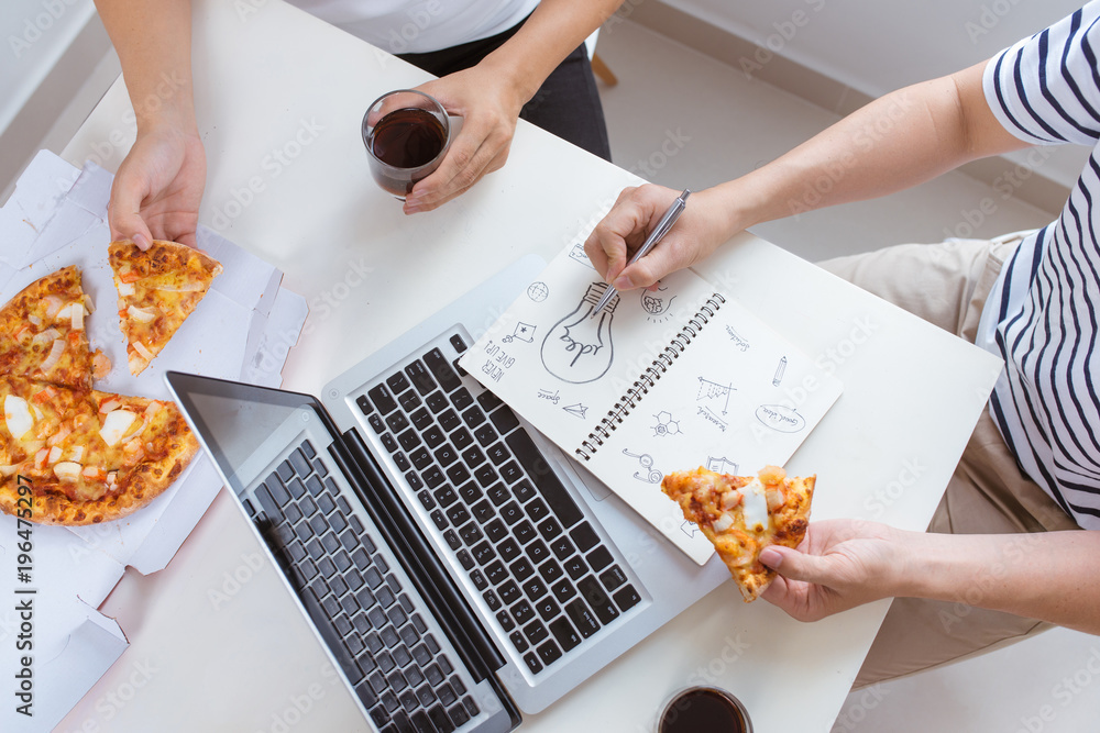 Lunch and people concept. Happy business team eating pizza in office Lunch and people concept. Happy business team eating pizza in office