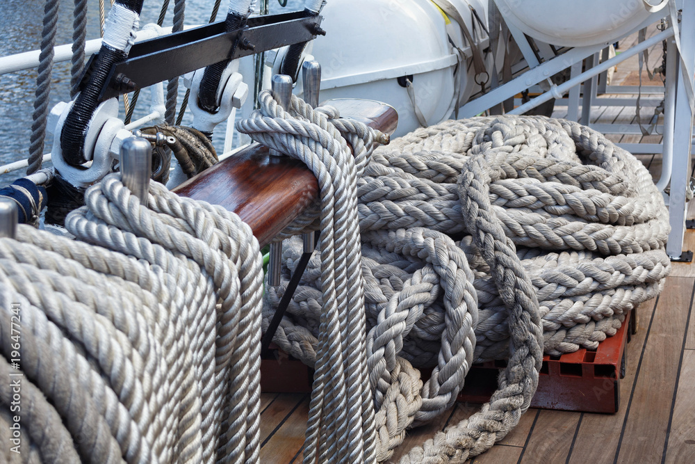 Steel belaying pins with ropes on a sailing ship.