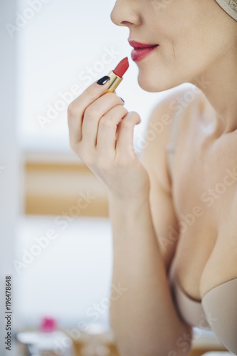 Woman Putting Lipstick