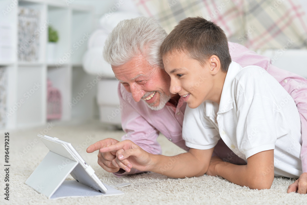 grandfather and grandson using laptop grandfather and grandson using laptop