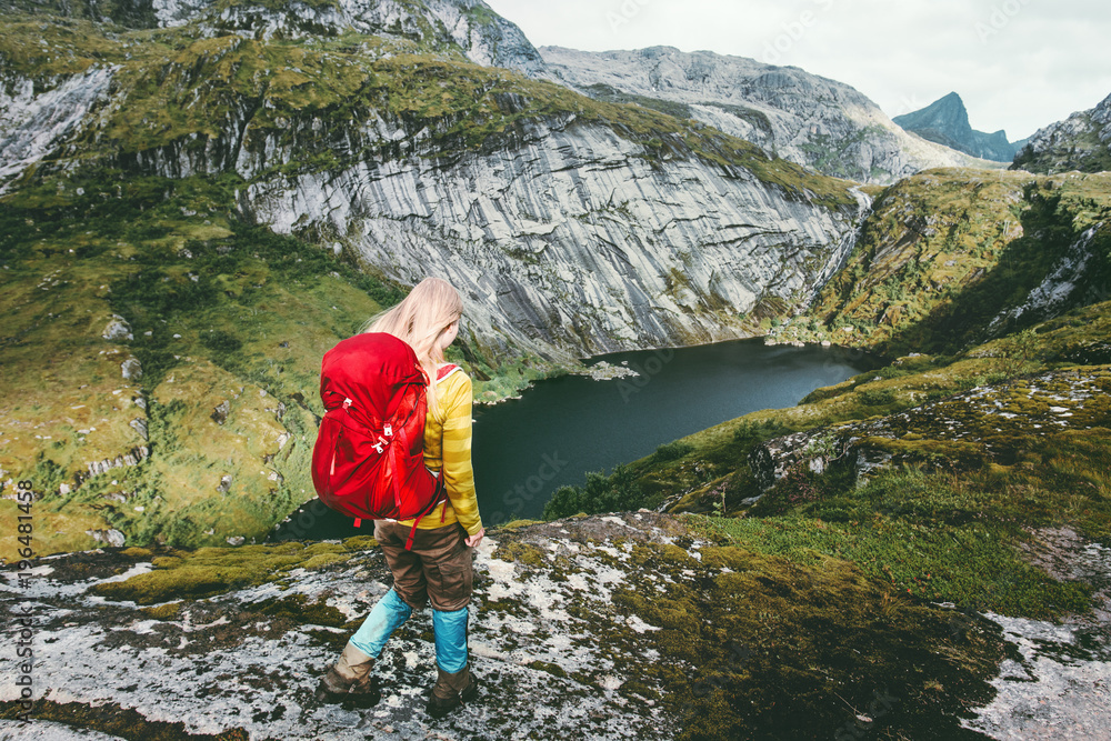 Naklejka premium Woman hiker with backpack trekking at mountains lake Traveling healthy lifestyle adventure concept active vacations outdoor