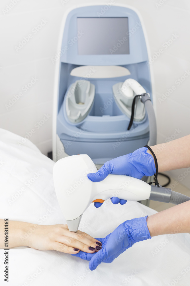 The process of laser depilation of female limbs in the beauty salon. The process of laser depilation of female limbs in the beauty salon.