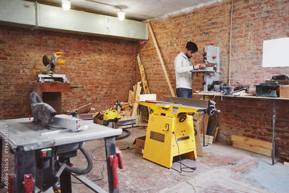 The young carpenter works in a workshop The young carpenter works in a workshop