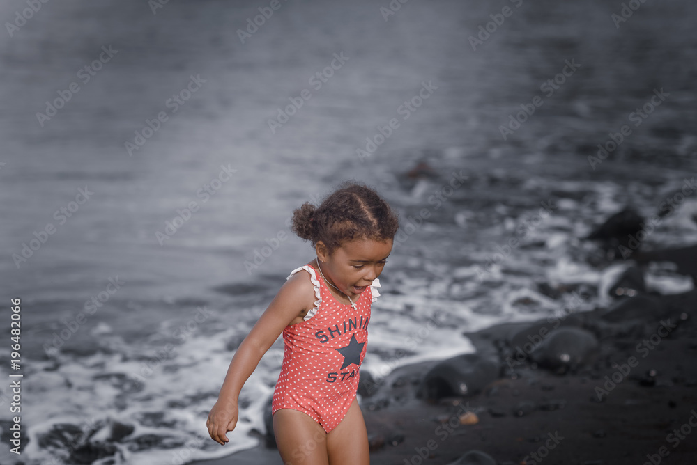 Fototapeta premium Happy girl jumping on the beach on the dawn time