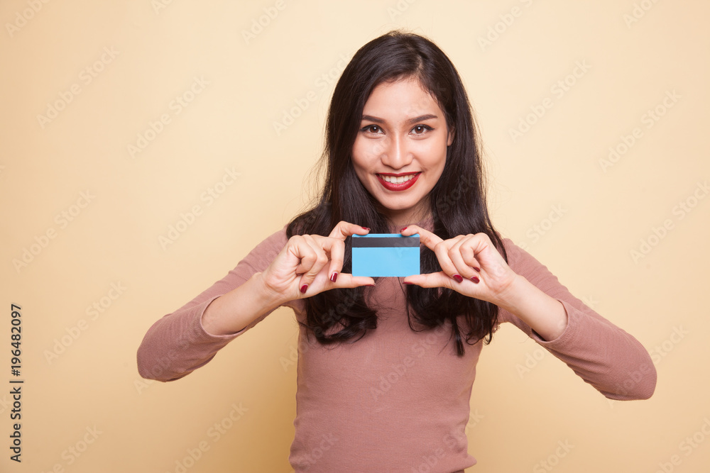 Young Asian woman smile with blank card. Young Asian woman smile with blank card.