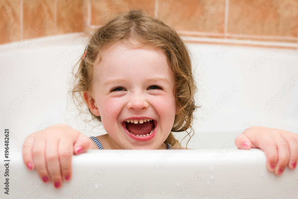Beautiful small girl laughing in the bathroom Beautiful small girl laughing in the bathroom