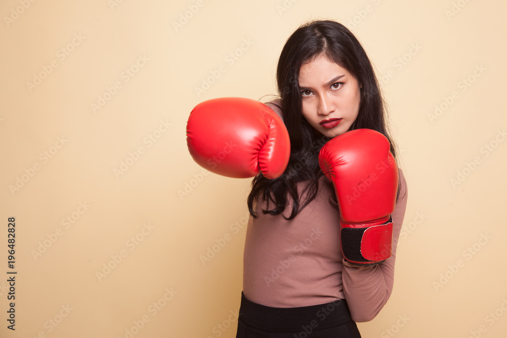 Young Asian woman with red boxing gloves.