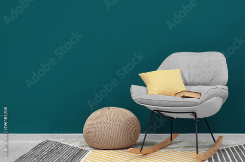 Trendy armchair near shaded...