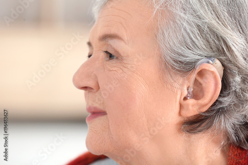 Mature woman with hearing a...