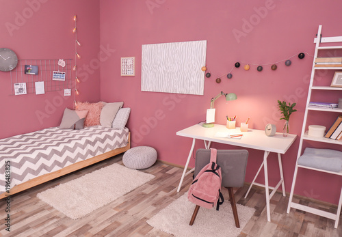 Comfortable bed and desk in...