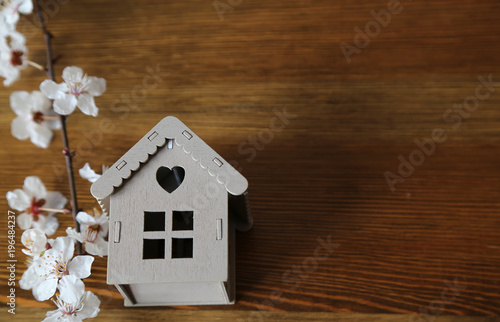 real estate and morgage. A wooden house on the wooden background .