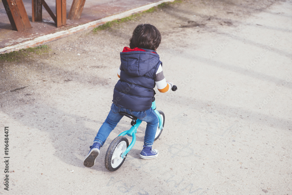 little boy playing outdoors with bicycle little boy playing outdoors with bicycle