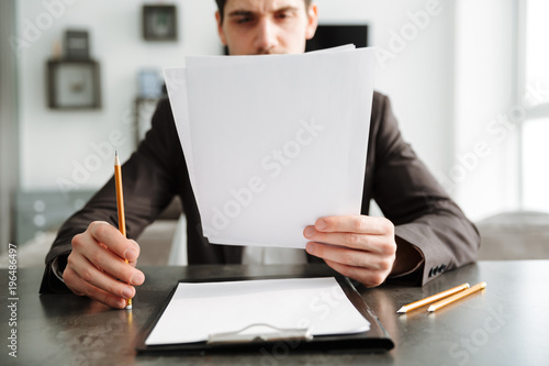 Concentrated young businessman working indoors