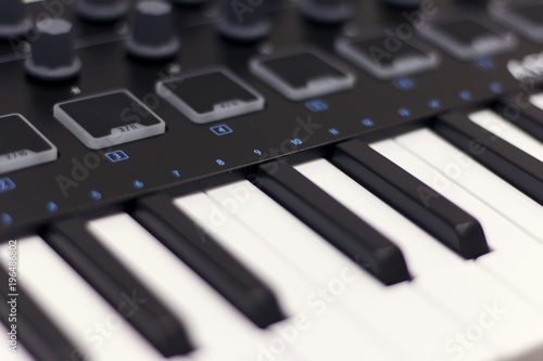 Wallpaper Mural Midi keyboard is white close-up. Modern electronic music, studio equipment. Torontodigital.ca