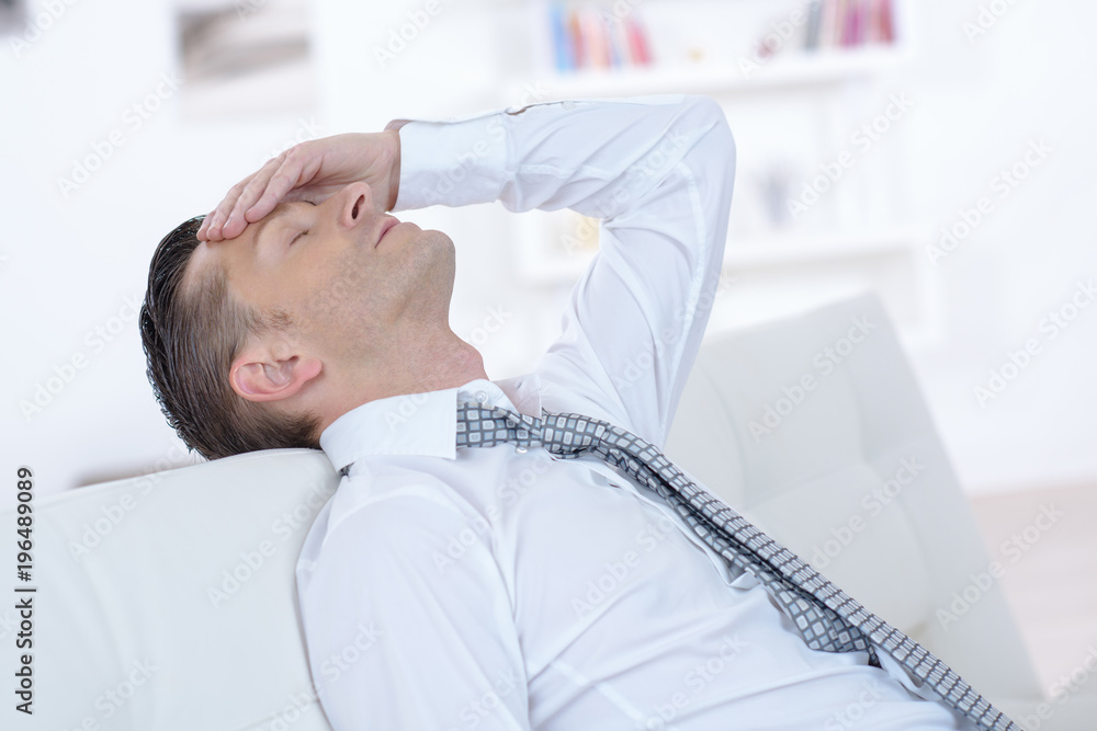 cportrait of a tired businessman having a headache cportrait of a tired businessman having a headache