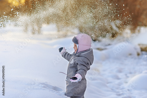 Cute child playing with snow