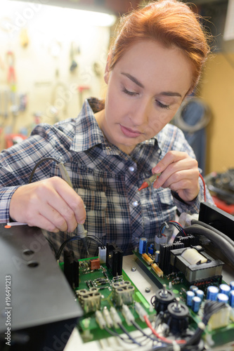 young woman technician repair electronics device