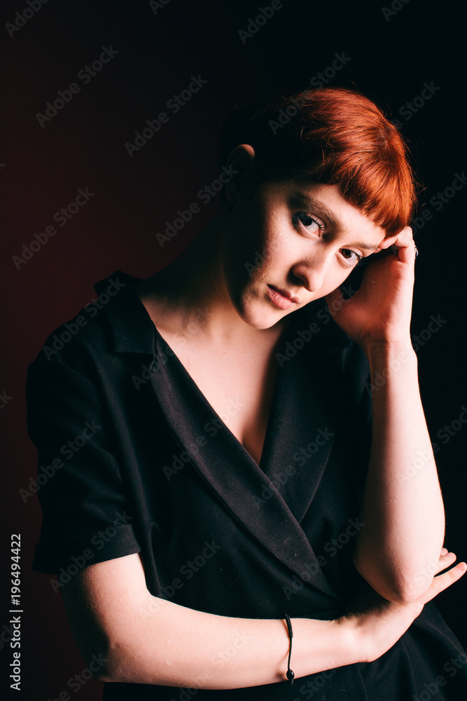 Fototapeta premium Beautiful girl freak with red hair and a short haircut
