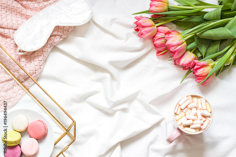 Breakfast in bed pastel flat lay frame composition with flowers, a cup o coffee and sweets. Concept spring top view Breakfast in bed pastel flat lay frame composition with flowers, a cup o coffee and sweets. Concept spring top view