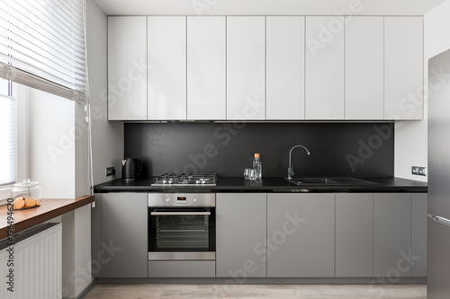 Modern kitchen with black worktop