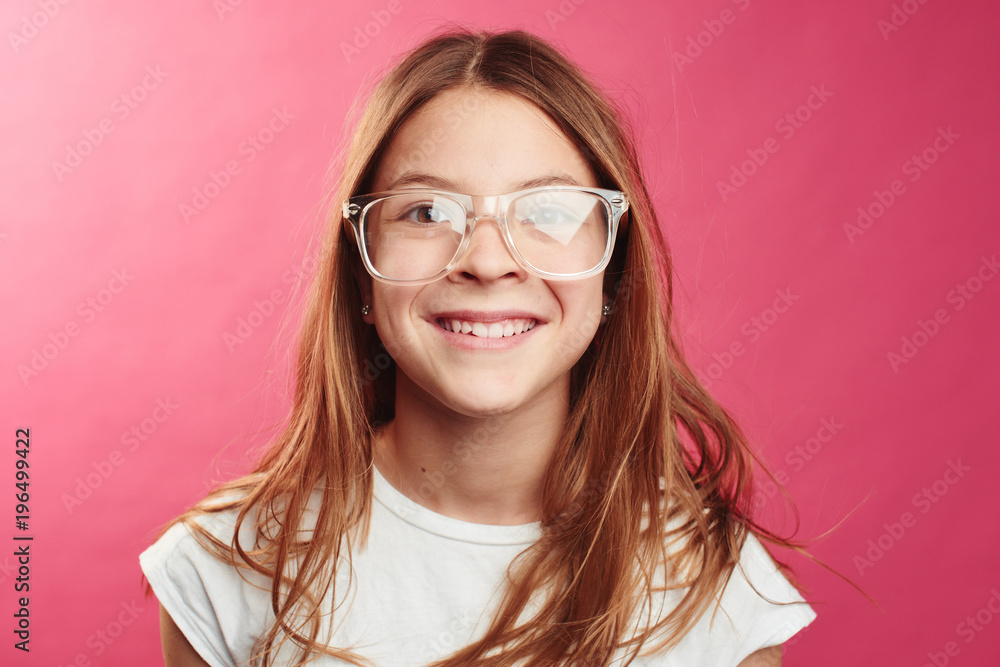 Obraz premium Portrait of brown-haired girl on pink background