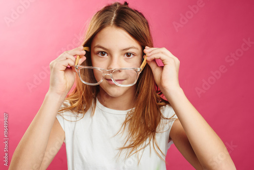 Photos Portrait of brown-haired girl on pink background