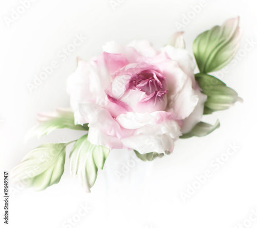 Realistic Fabric Silk flower in pink and white colors rose hand made on white background. Vintage style, retro, card, copy space, close-up. red, green