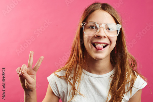 Portrait of brown-haired girl on pink background
